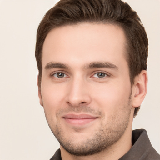 Joyful white young-adult male with short  brown hair and brown eyes