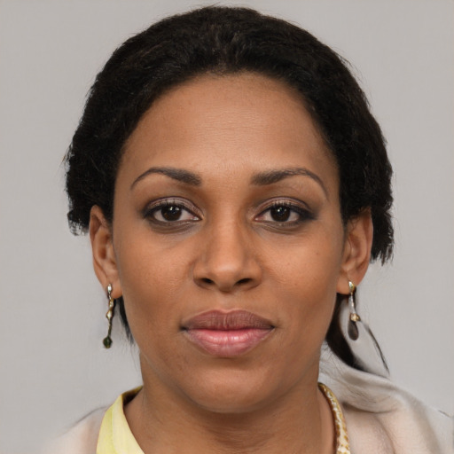 Joyful latino young-adult female with short  brown hair and brown eyes