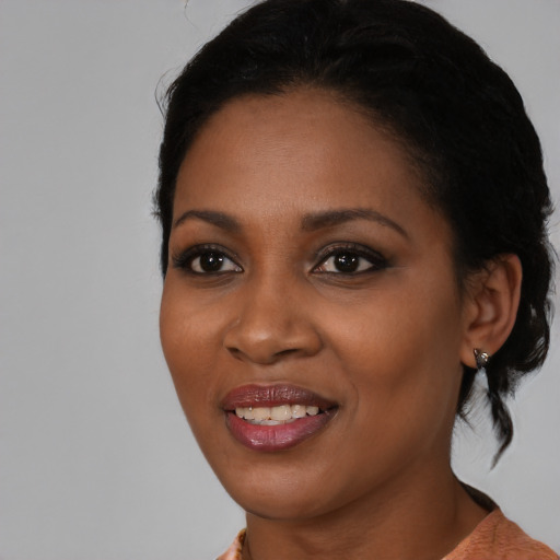 Joyful black young-adult female with medium  black hair and brown eyes