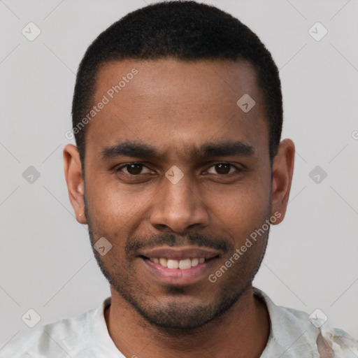 Joyful black young-adult male with short  black hair and brown eyes