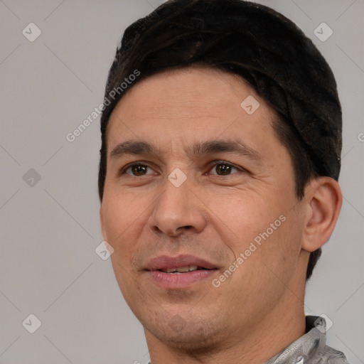 Joyful white adult male with short  black hair and brown eyes