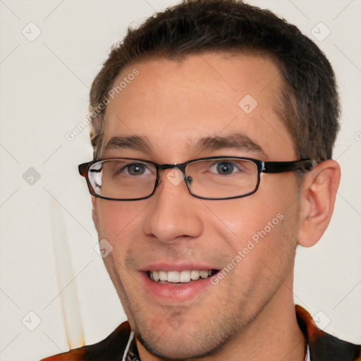 Joyful white young-adult male with short  brown hair and brown eyes