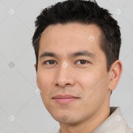 Joyful white young-adult male with short  black hair and brown eyes