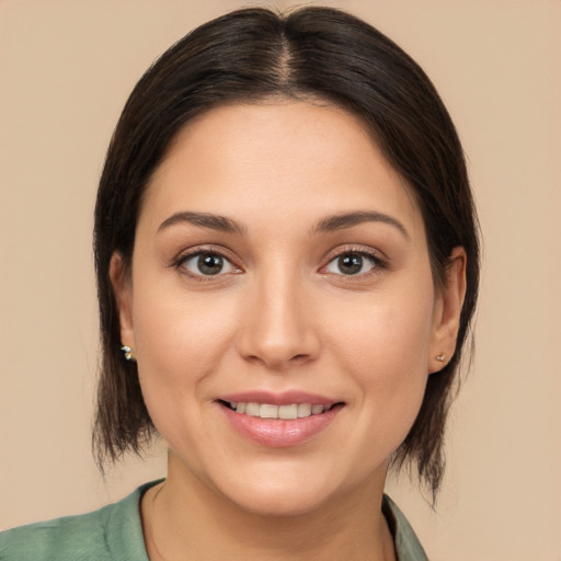 Joyful white young-adult female with medium  brown hair and brown eyes