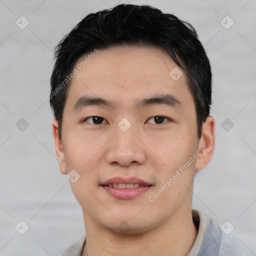 Joyful asian young-adult male with short  black hair and brown eyes