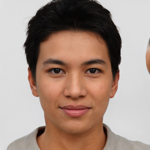 Joyful asian young-adult male with short  black hair and brown eyes