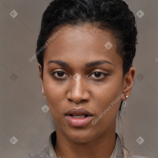 Joyful black young-adult female with short  black hair and brown eyes