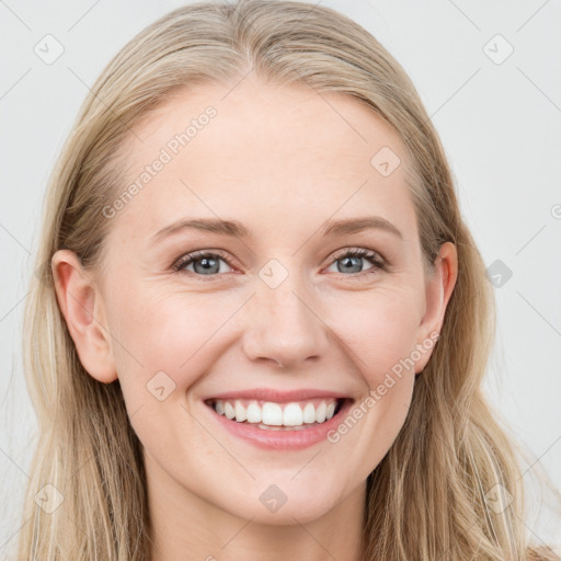 Joyful white young-adult female with long  brown hair and blue eyes