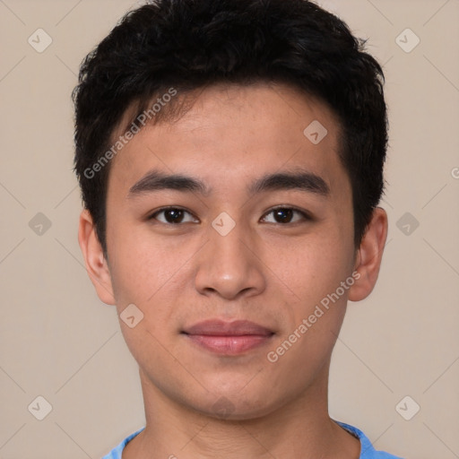 Joyful asian young-adult male with short  brown hair and brown eyes