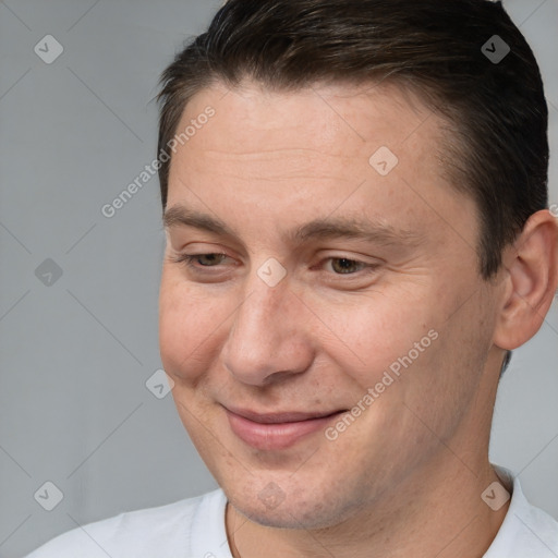 Joyful white adult male with short  brown hair and brown eyes