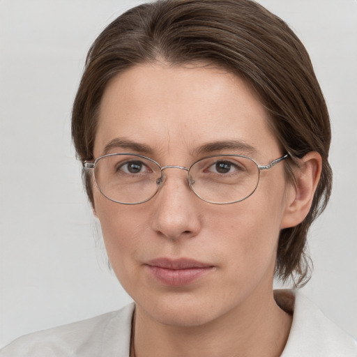 Joyful white adult female with medium  brown hair and grey eyes