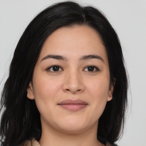 Joyful asian young-adult female with long  brown hair and brown eyes
