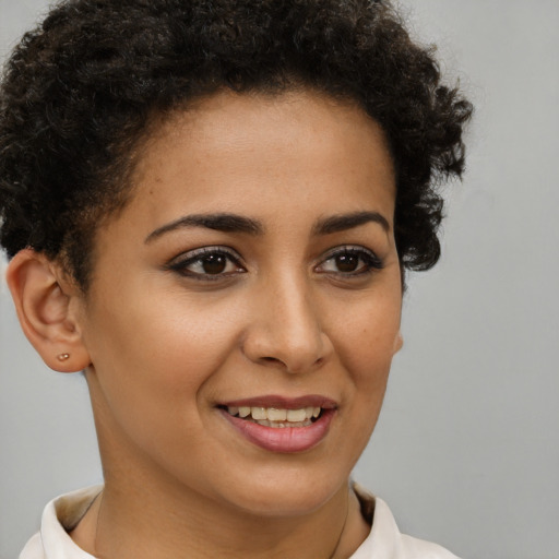 Joyful latino young-adult female with short  brown hair and brown eyes