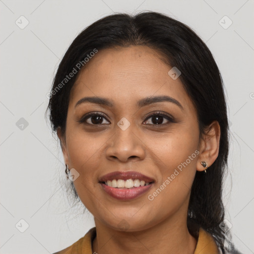 Joyful latino young-adult female with medium  brown hair and brown eyes