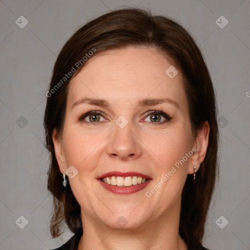 Joyful white adult female with medium  brown hair and grey eyes