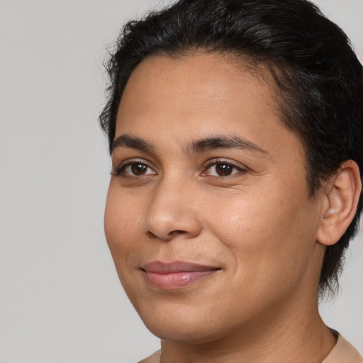 Joyful latino young-adult female with short  brown hair and brown eyes