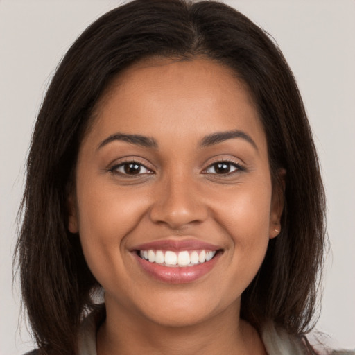 Joyful white young-adult female with long  brown hair and brown eyes