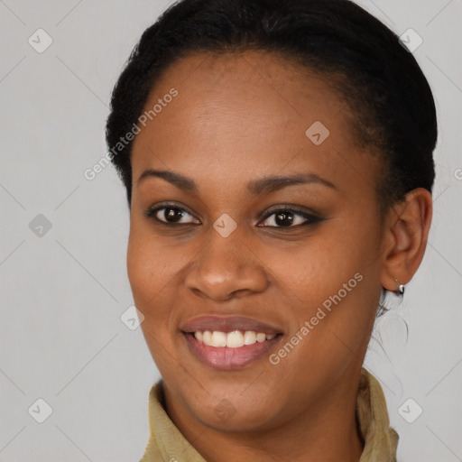 Joyful black young-adult female with short  brown hair and brown eyes