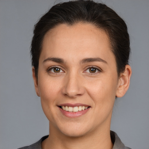 Joyful white young-adult female with short  brown hair and brown eyes