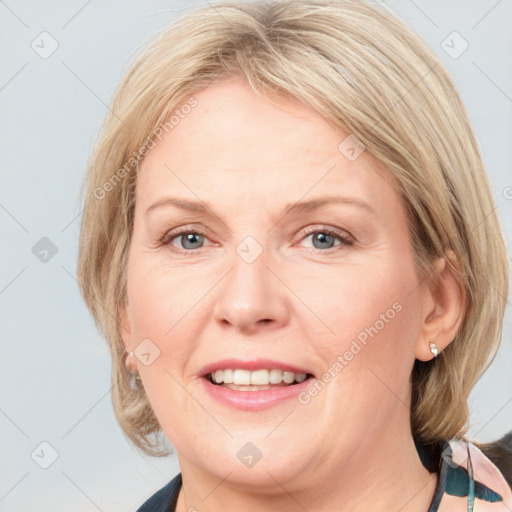 Joyful white adult female with medium  brown hair and blue eyes