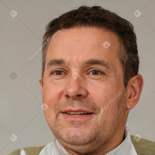 Joyful white adult male with short  brown hair and brown eyes