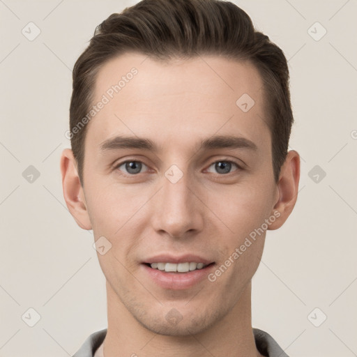 Joyful white young-adult male with short  brown hair and grey eyes