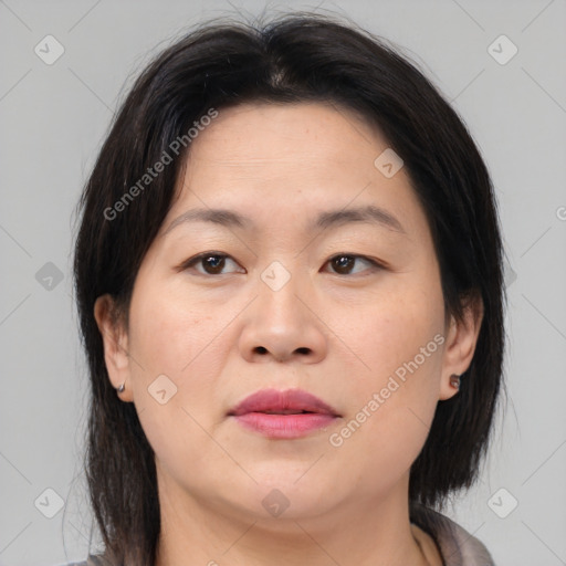 Joyful asian adult female with medium  brown hair and brown eyes