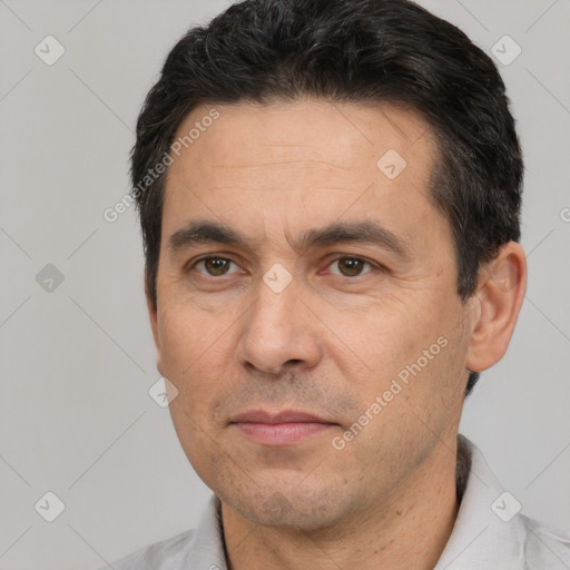 Joyful white adult male with short  black hair and brown eyes