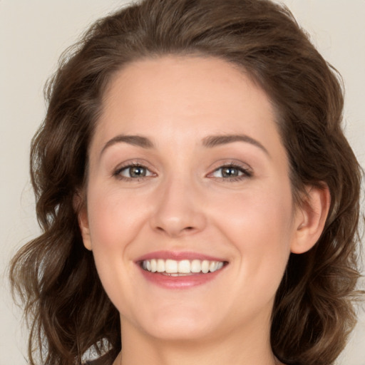 Joyful white young-adult female with long  brown hair and green eyes