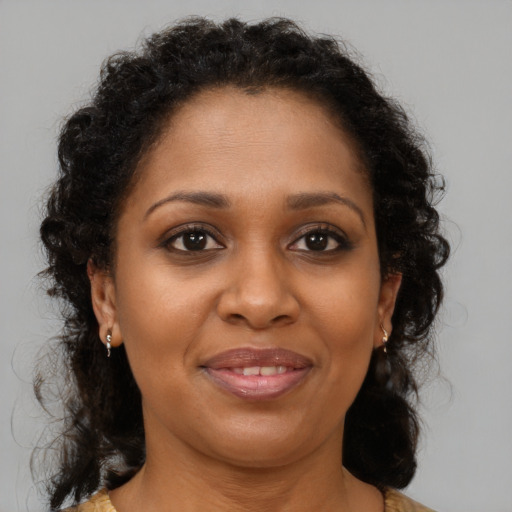 Joyful black young-adult female with medium  brown hair and brown eyes
