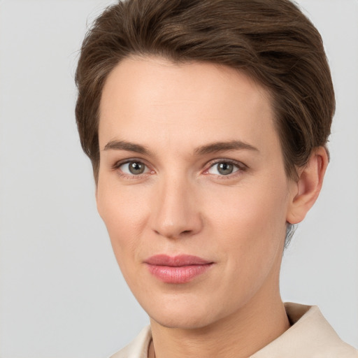 Joyful white young-adult female with short  brown hair and grey eyes