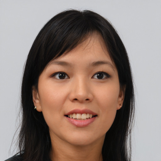 Joyful asian young-adult female with long  brown hair and brown eyes