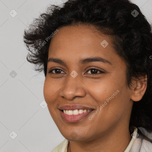 Joyful black young-adult female with long  brown hair and brown eyes