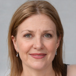 Joyful white adult female with medium  brown hair and grey eyes