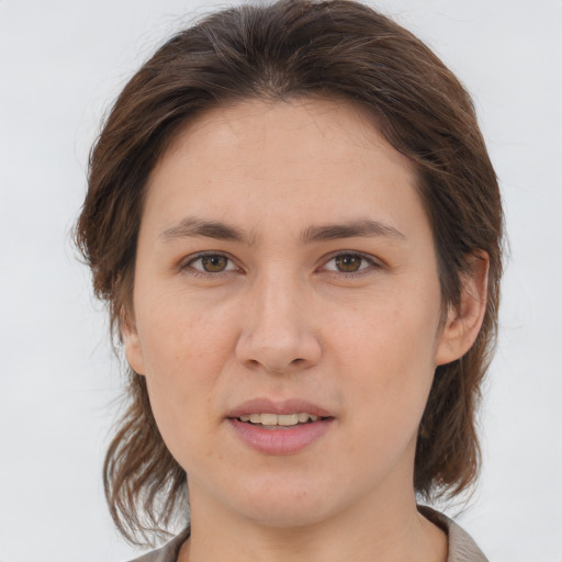 Joyful white young-adult female with medium  brown hair and brown eyes