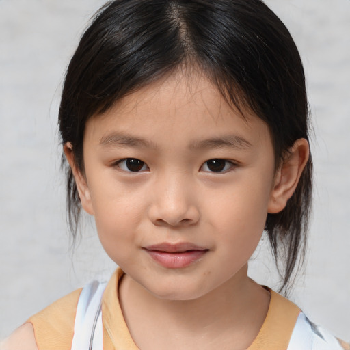 Joyful asian child female with medium  brown hair and brown eyes