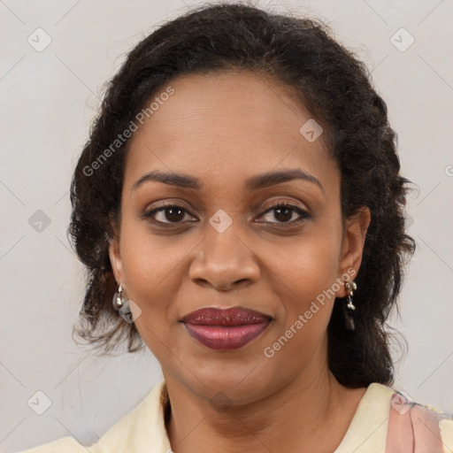 Joyful black adult female with medium  brown hair and brown eyes