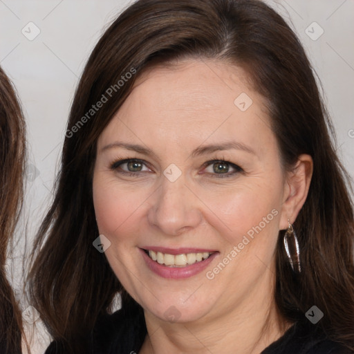 Joyful white adult female with long  brown hair and brown eyes