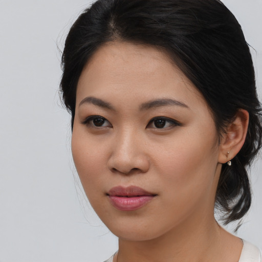 Joyful asian young-adult female with medium  brown hair and brown eyes