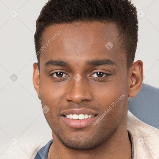 Joyful black young-adult male with short  brown hair and brown eyes