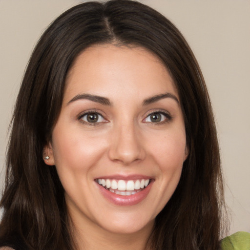 Joyful white young-adult female with long  brown hair and brown eyes