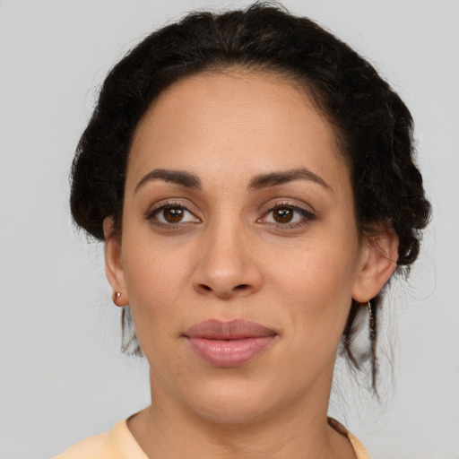 Joyful latino young-adult female with short  brown hair and brown eyes