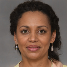 Joyful black adult female with medium  brown hair and brown eyes