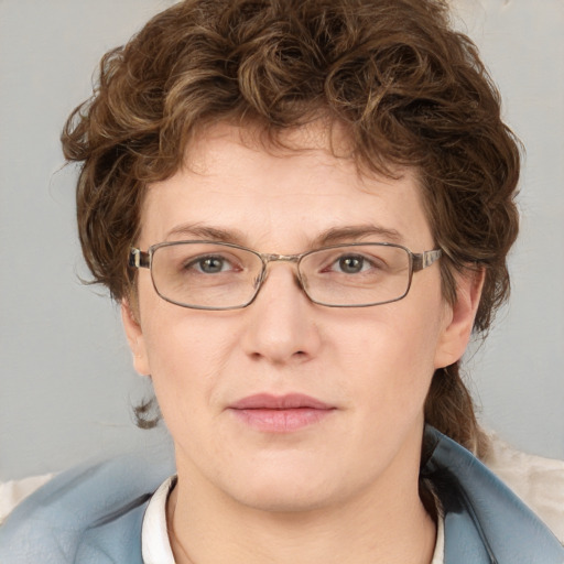 Joyful white adult female with medium  brown hair and blue eyes