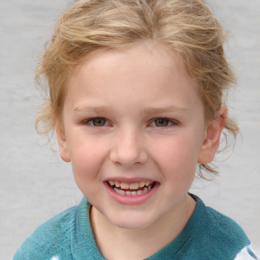 Joyful white child female with short  brown hair and blue eyes