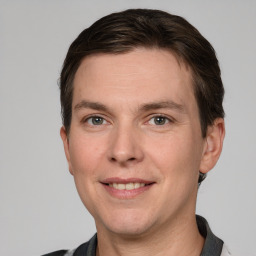 Joyful white adult male with short  brown hair and grey eyes