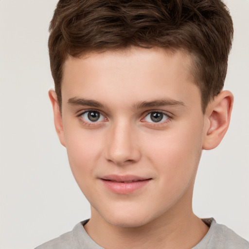 Joyful white child male with short  brown hair and brown eyes