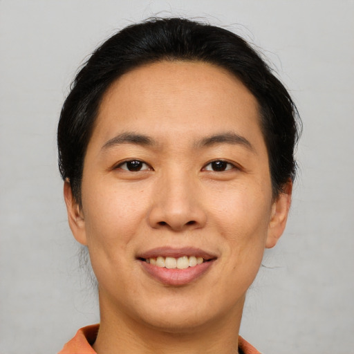Joyful asian young-adult female with short  brown hair and brown eyes