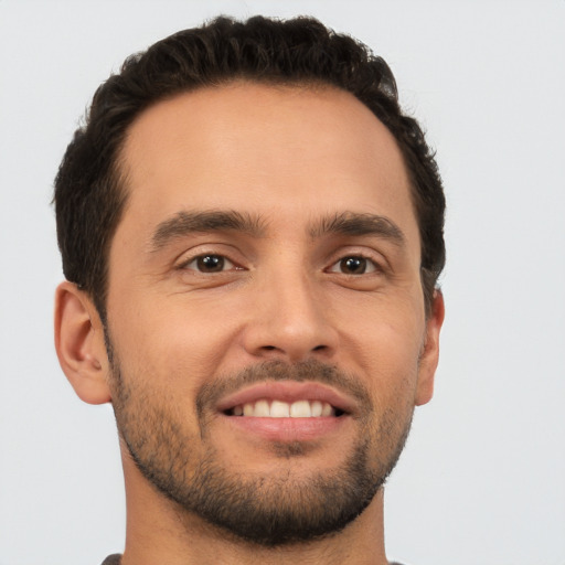 Joyful white young-adult male with short  brown hair and brown eyes