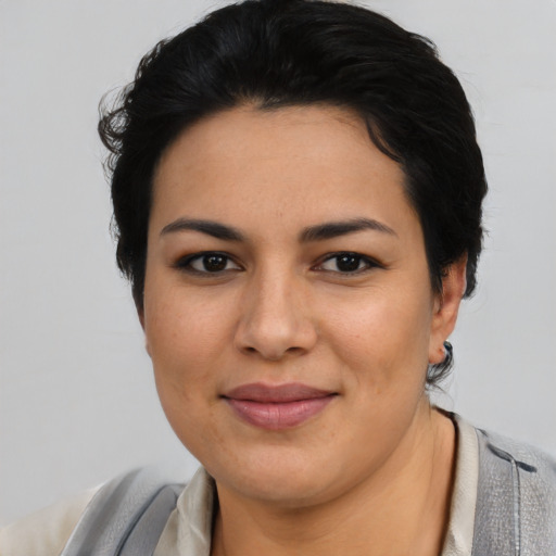 Joyful latino young-adult female with short  brown hair and brown eyes